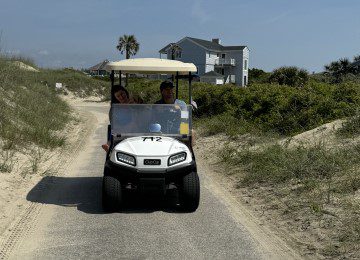 rental golf cart on the beach with 2 passengers